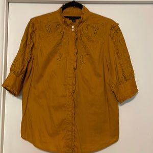 Jcrew size Medium short sleeve pumpkin color eyelet blouse with ruffles.